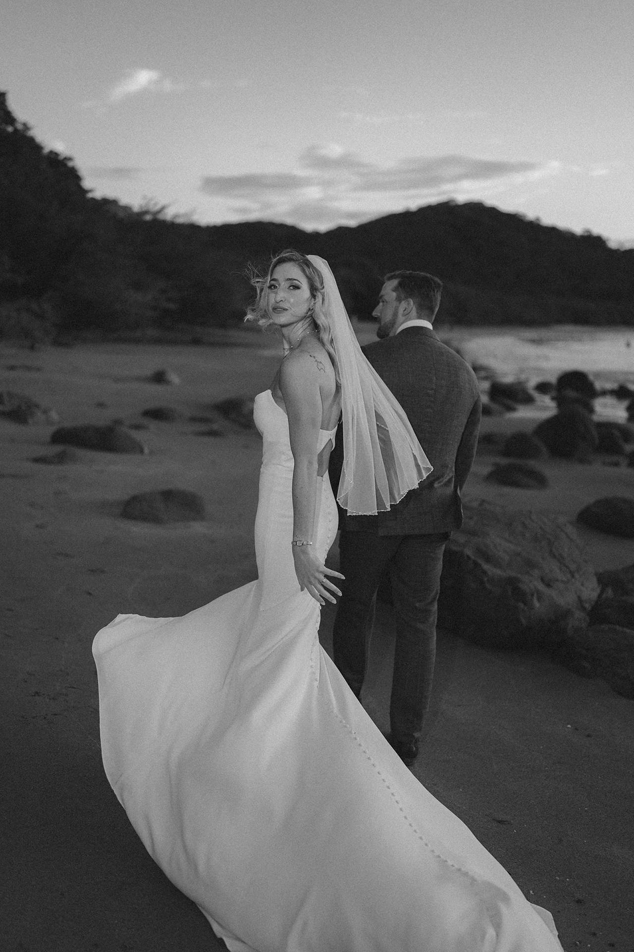 Newlyweds together on a quiet beach