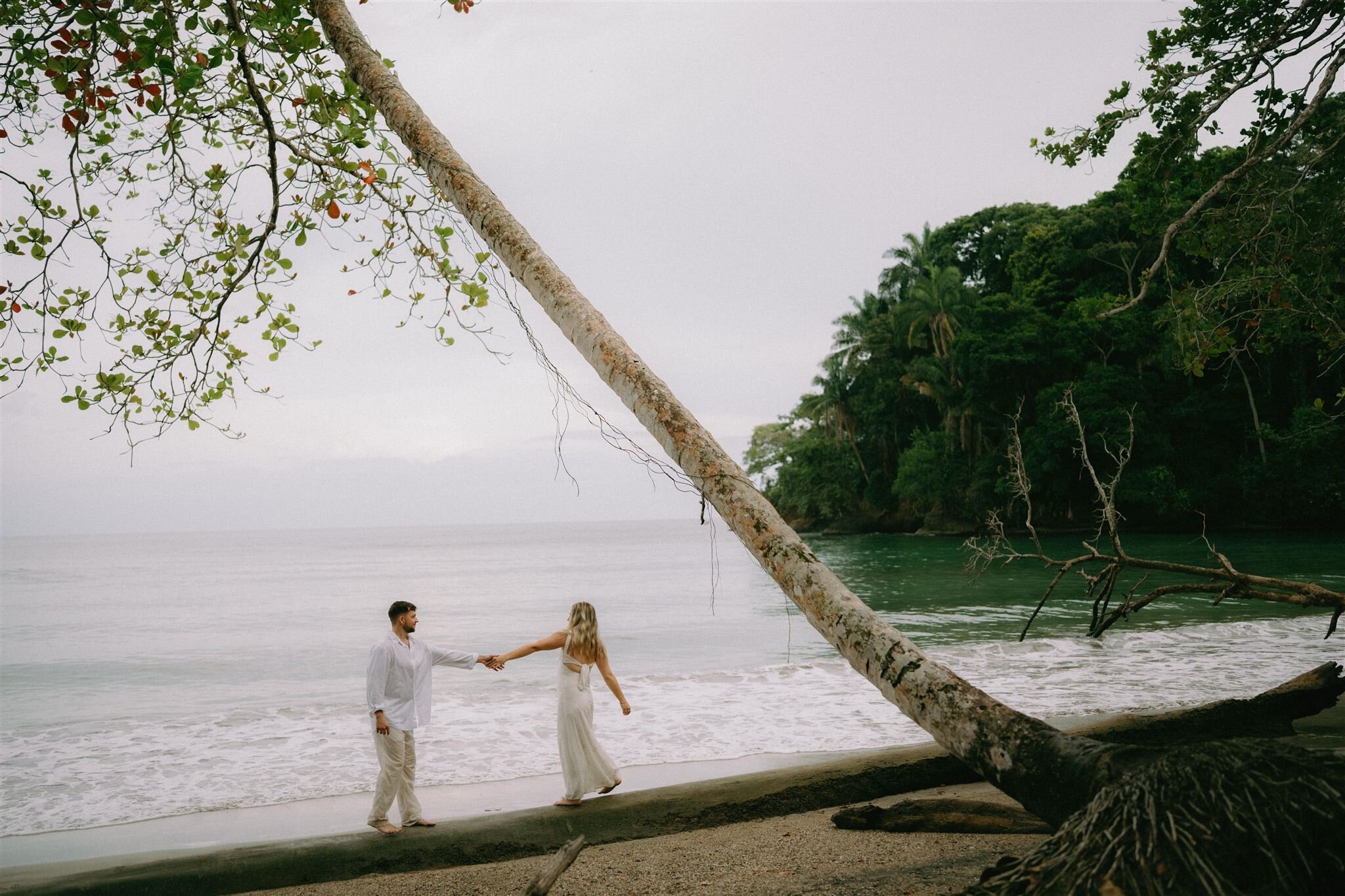 A couple holding hands on the Costa Rica coast